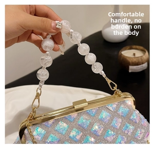 Detail of silver checkerboard sequin evening bag with clear beaded handle and gold clasp