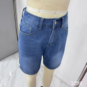 Detail view of washed blue denim capri pants featuring classic five-pocket design and seams