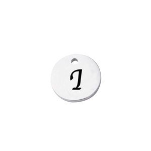 Detailed close-up of a polished stainless steel round tag with letter J engraving