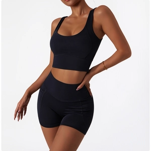Detail showing the elastic fit and stitching of black high-waist yoga shorts with pockets
