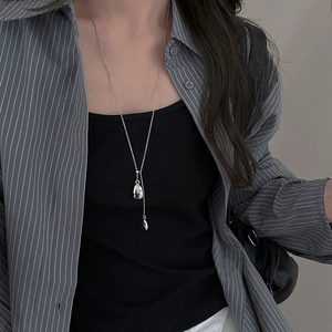 Minimalist silver-plated necklace featuring an abstract face pendant on a thin metal chain