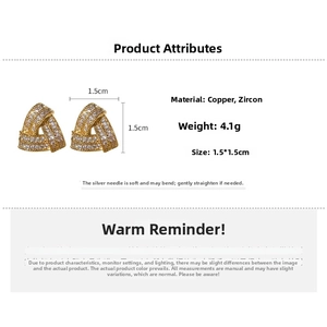 Macro shot of gold-plated triangle twist earrings with cubic zirconia and silver pins
