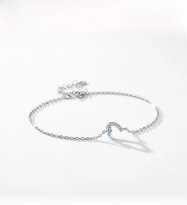 Detail of S925 sterling silver heart bracelet with pavé zircons and light blue enamel