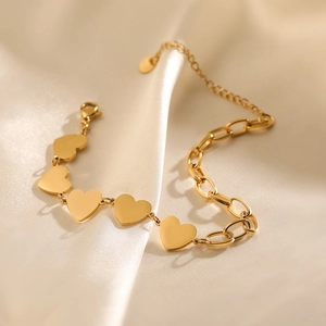 Minimalist 18K gold plated stainless steel heart charm bracelet on elegant beige silk