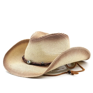 Detail of hand-woven straw cowboy hat with gradient effect and evil eye charm