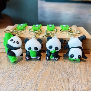 Detailed view of four cute panda keychains with green silicone straps and golden rings