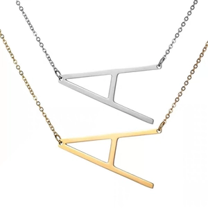 Detailed view of large A letter pendants in polished gold and silver finishes on thin chains