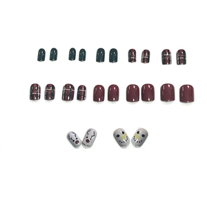 Cute Christmas press-on nails set with reindeer patterns and festive plaid designs
