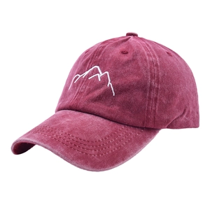 Vintage washed red baseball cap featuring white mountain embroidery and curved brim