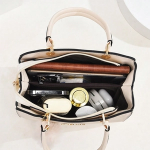 Modern beige PU leather tote bag with a spacious interior and gold-toned hardware accents