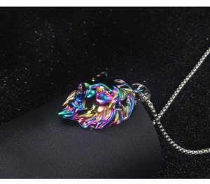Macro shot of iridescent lion head pendant with silver box chain on dark textured surface