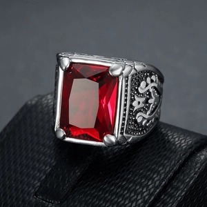 Macro detail of men's vintage silver ring with large square red gem and tulip engraving