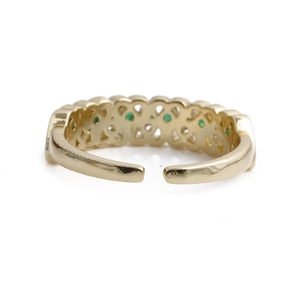 Detail view of gold adjustable open ring featuring green zircon heart-shaped accents