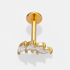 Macro shot of gold stainless steel stud with marquise-cut zircon in leaf crown shape