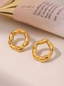 Irregular golden wavy hoop earrings with hammered texture finish and vintage metal luster