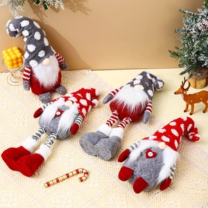 Nordic Christmas gnomes plush dolls in red and white on a festive decorated tabletop