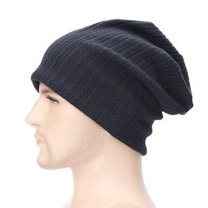 Close-up of dark blue striped knit beanie showing ribbed texture and slouchy style
