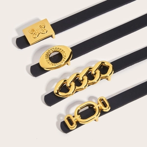 Set of four thin black leather belts for women with diverse golden metallic buckles