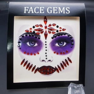 Halloween face gems with black and deep red rhinestones for spooky party makeup looks