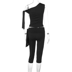 Rear view of sleek black one-shoulder top and lace-up shorts set on invisible mannequin