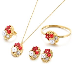 Luxury gold stainless steel jewelry set with red flowers and white pearls on white background