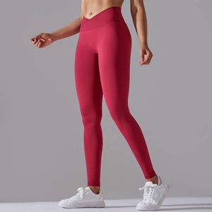 Detail view of red seamless yoga leggings with cross-waist V-cut design for women