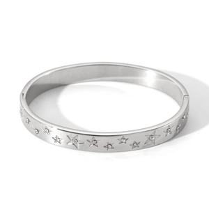Close-up of silver star engraved bangle with sparkling cubic zirconia stones