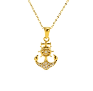 Macro detail of gold anchor pendant featuring micro-pave cubic zirconia crystals