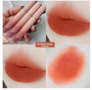 Close-up of velvet matte lip glaze in maple ginger orange shade on lips and skin
