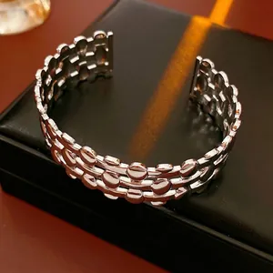 Three-layer silver metal cuff bracelet featuring a hollow-out woven textured design