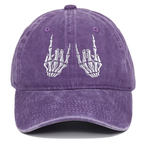 Close-up of rock hand skeleton embroidery on purple washed cotton baseball cap
