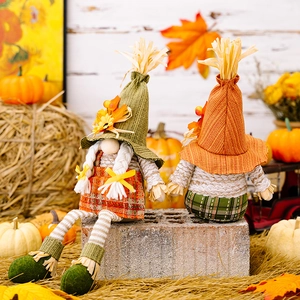 Harvest festive gnomes with maple leaf hats and straw accents for autumn decoration