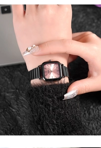 Detail of GEDI square watch with pink sunray dial and black metal link band on wrist