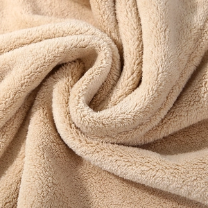 Macro detail of thick beige coral fleece fabric showing soft high-density fiber texture