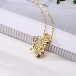 Macro detail of golden butterfly wing pendant with sparkling colorful zircon stones