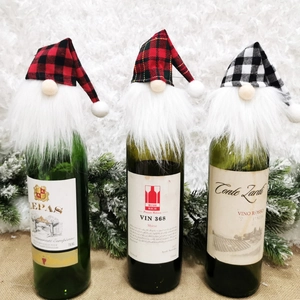 Three festive Christmas gnome wine bottle covers with plaid patterns and white faux fur trim