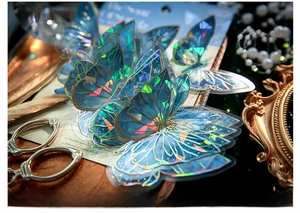 Detailed macro of blue holographic butterfly stickers with gold foil and shell luster