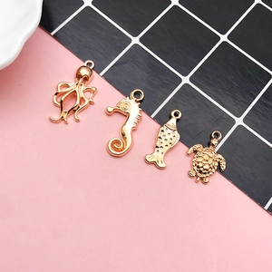 Detailed close-up of golden sea animal pendants featuring octopus, seahorse and turtle charms