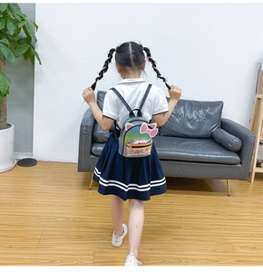 Detail of colorful gradient backpack with cat ears and bow on child back