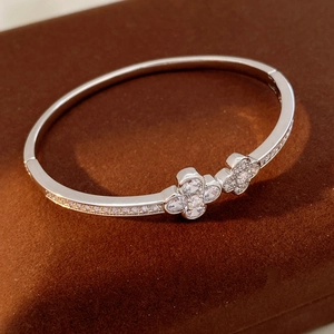 Detail of silver clover bangle with cubic zirconia pave and side crystal accents