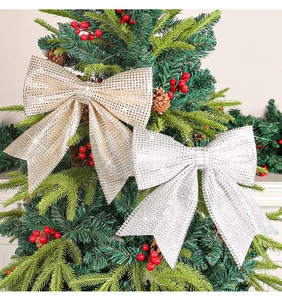 Close-up of sparkling gold and silver glitter mesh bows on a Christmas tree branch