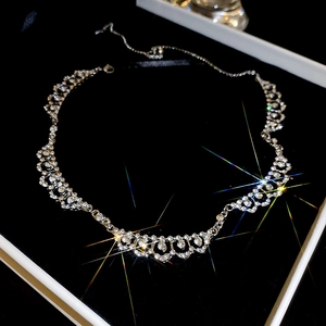 Detail of silver lace necklace with sparkling rhinestones and elegant starburst effect
