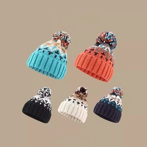 Winter knit hats with pom poms featuring Nordic geometric patterns in five vibrant colors