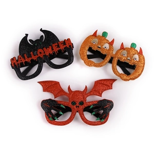 Detail of Halloween party eyewear with glittering orange pumpkins and bats