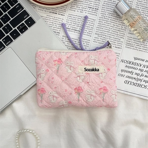 Detailed shot of a floral quilted cotton makeup bag with rabbit patterns and pink roses