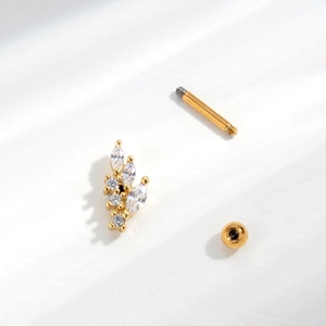 Detail of golden stainless steel leaf stud earring with clear zircon and screw-back ball