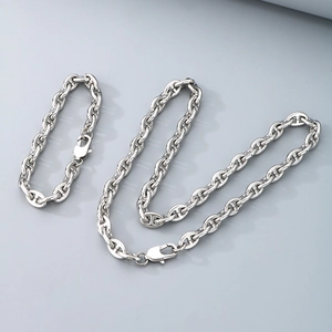 Elegant silver stainless steel jewelry set featuring a classic anchor link necklace and bracelet