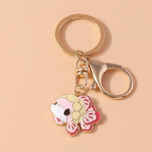 Close-up of a pink and yellow enamel koi fish keychain with gold-plated metal clasp