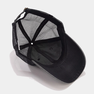 Detailed interior view of a gray trucker hat showing breathable mesh and stitching