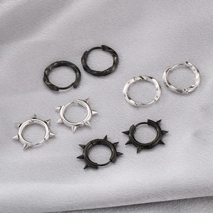 Macro view of punk style mobius twisted and spiked stud earrings in silver and black metal